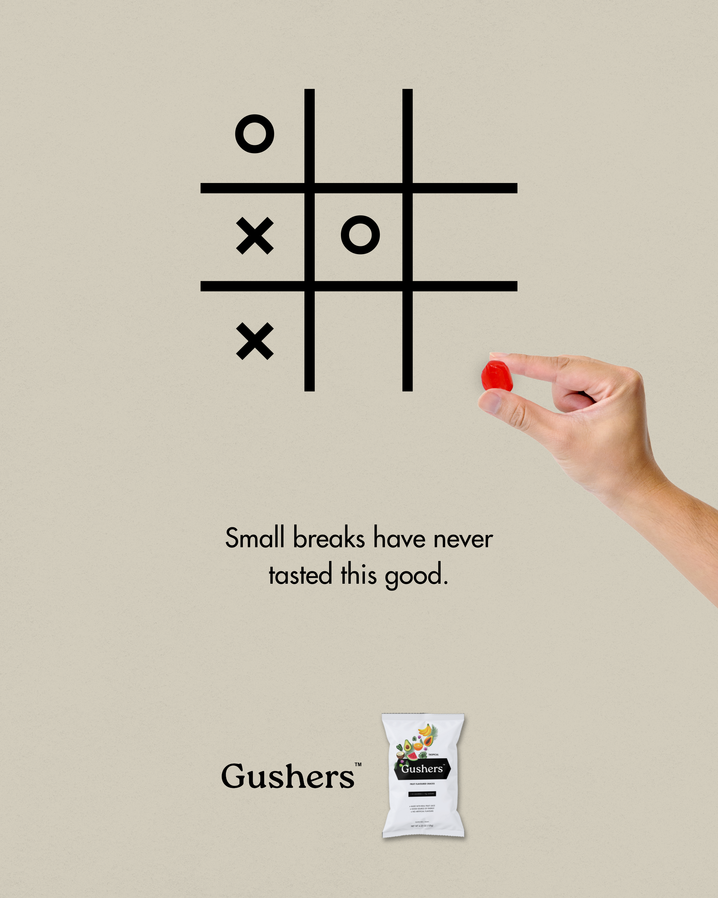 Ad featuring a tic-tac-toe grid where a hand places a Gushers fruit snack in one square to complete a winning line.