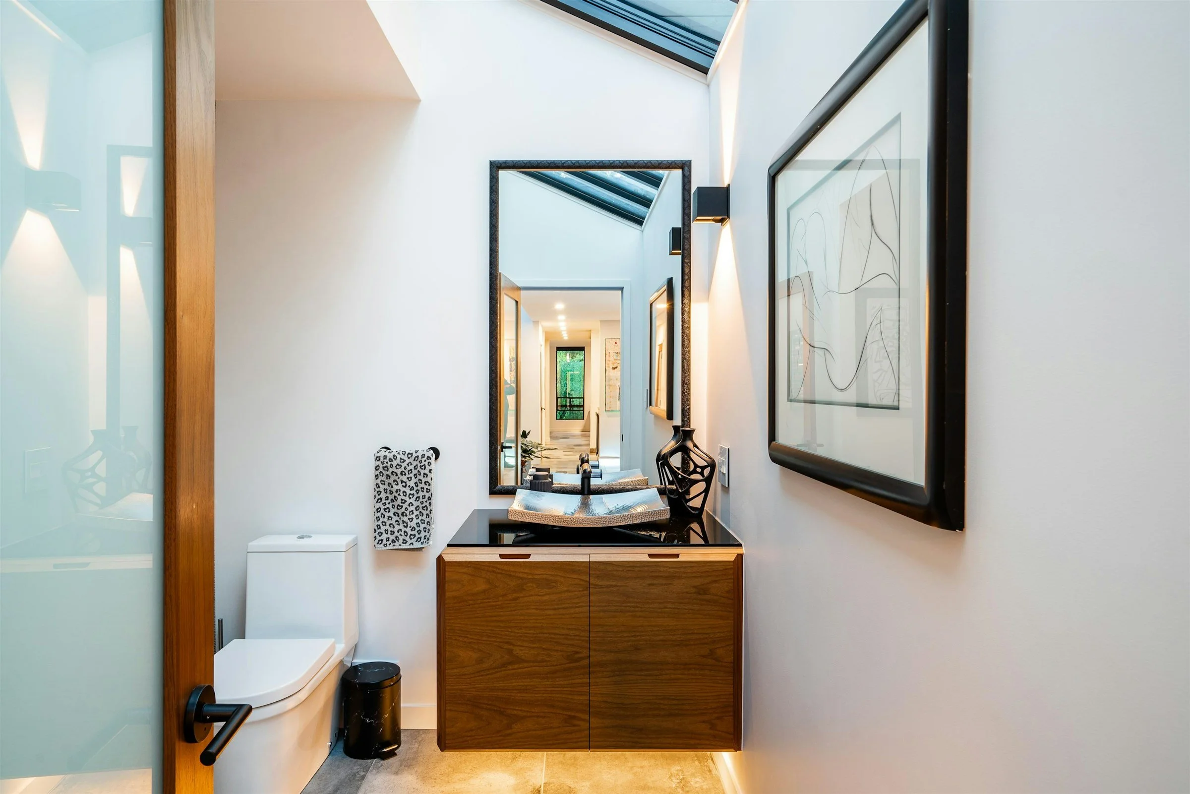 Quality bathroom renovation with wooden cabinets and minimalist design.