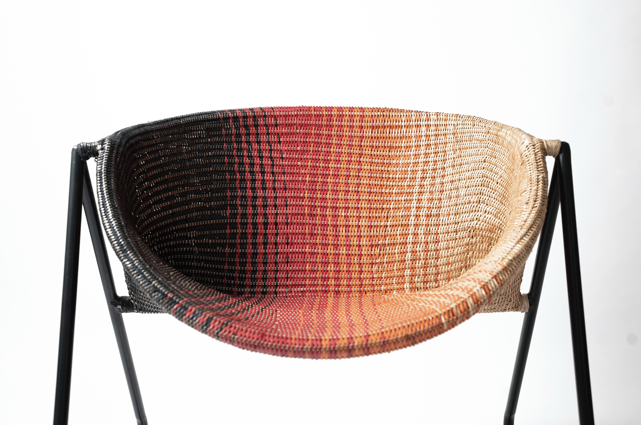 Colorful woven chair with black metal legs on a white background.