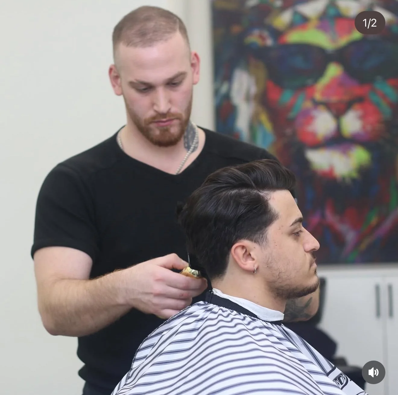 Barber performing precision haircut service at Finest Touch.