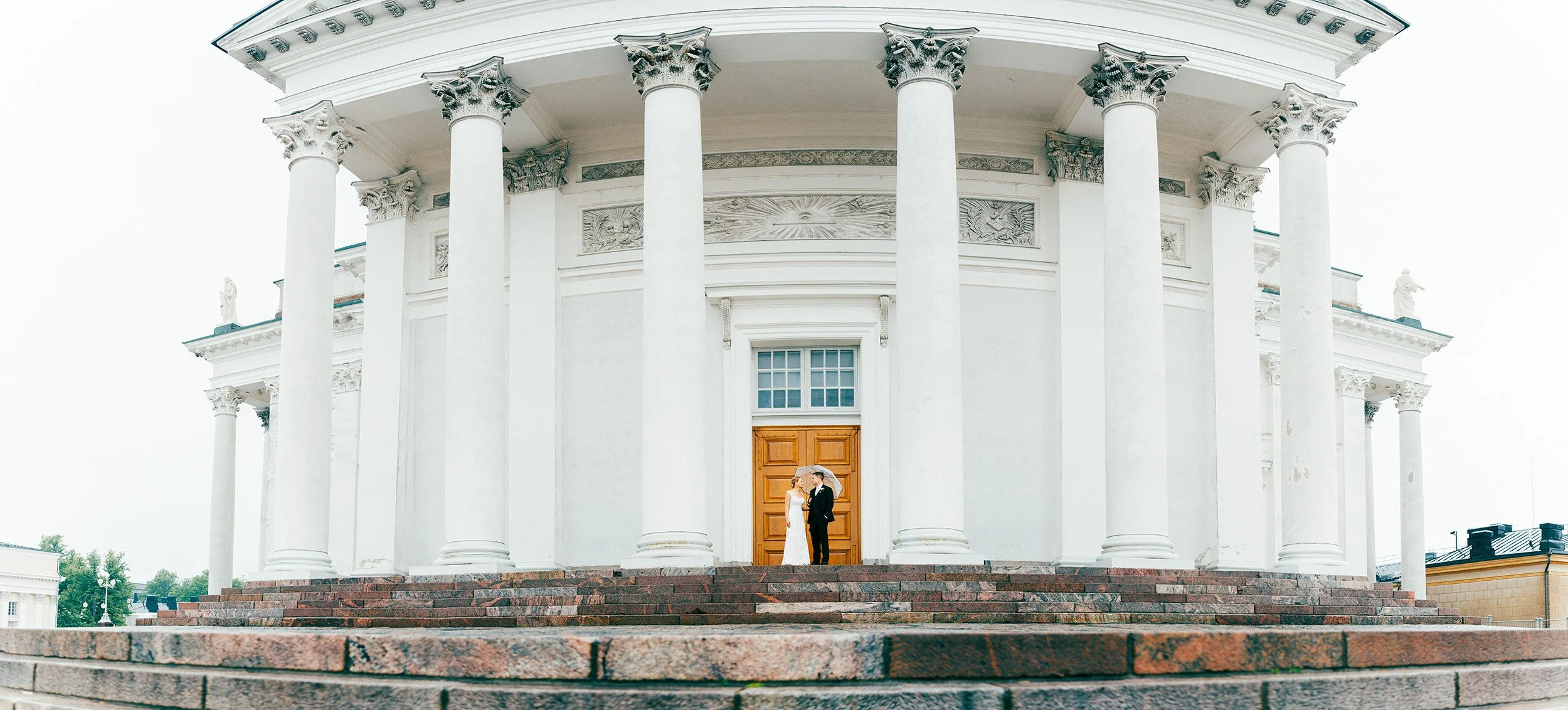 Panoramakuva hääparista Helsingin tuomiokirkon majesteettisten pylväiden katveessa. Hääkuvaus Helsinki - Hyvän mielen hääkuvaaja Sami Turunen.