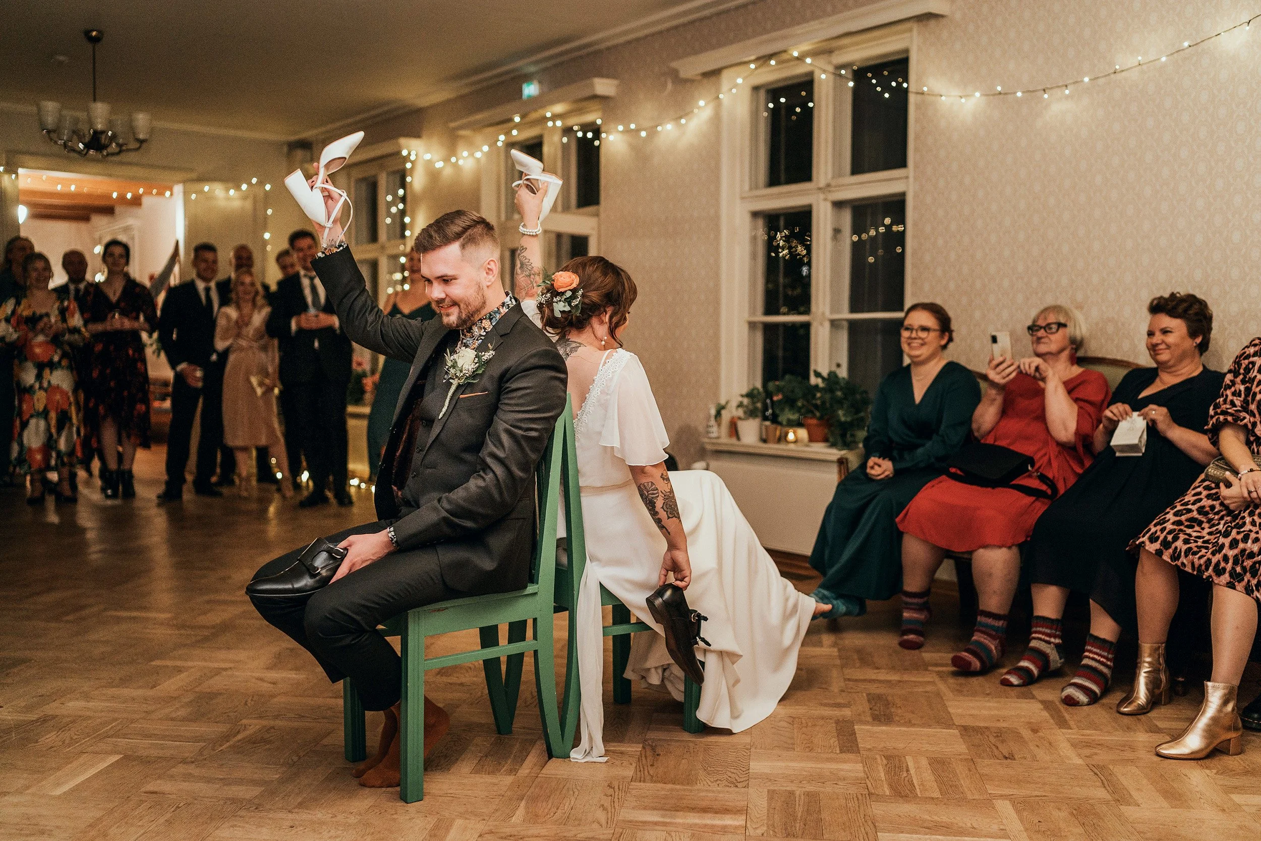 Perinteinen kenkäleikki Bokvillanin juhlatilassa Helsingin Arabiassa. Hääkuvaus Helsinki - Hyvän mielen hääkuvaaja Sami Turunen.