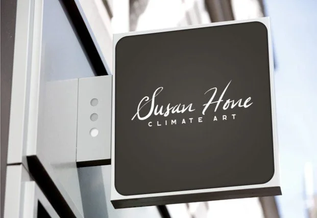 Outdoor sign for Susan Home Climate Art mounted on building exterior.