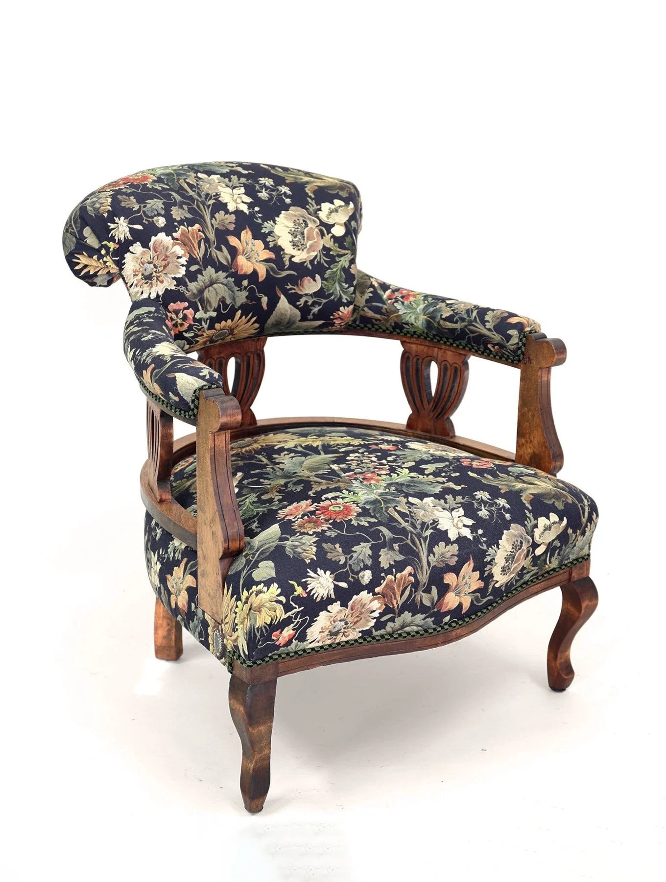 Vintage armchair with floral upholstery and wooden frame.