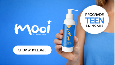 Person holding a bottle of Prograde Teen Skincare product in front of a blue background with the brand name 'Mooi by Monuskin' and a 'Shop Wholesale' button.