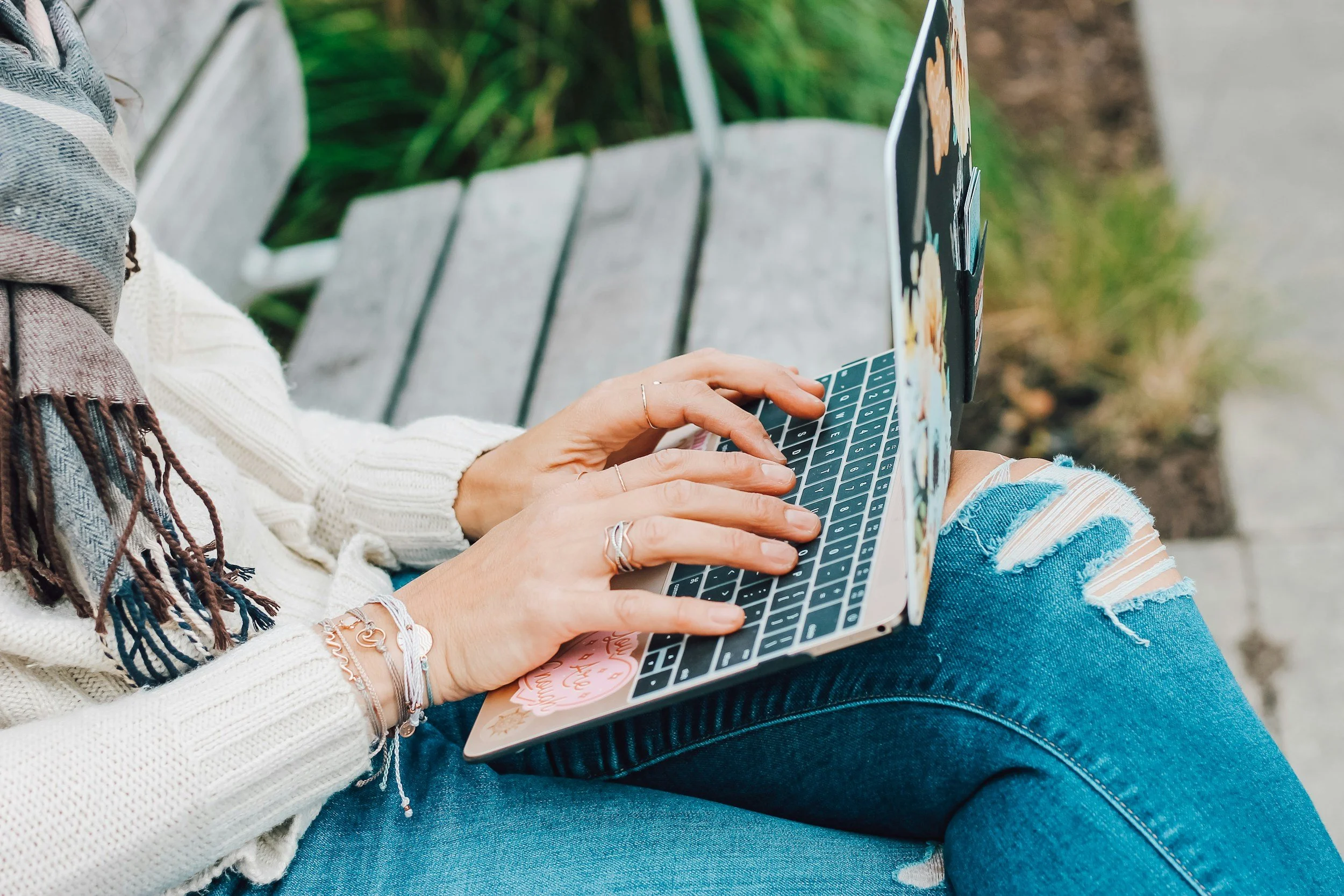 Person using a laptop outdoors for online Christian counseling and faith-based telehealth therapy in Minnesota