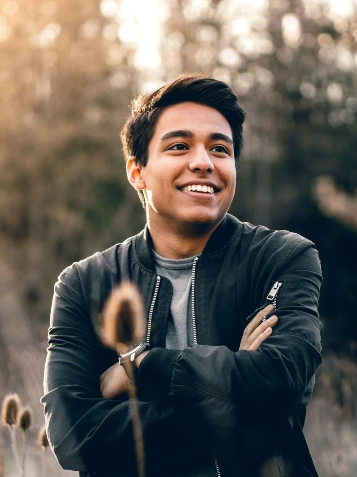 Man enjoying a peaceful moment in an open field surrounded by tall grass