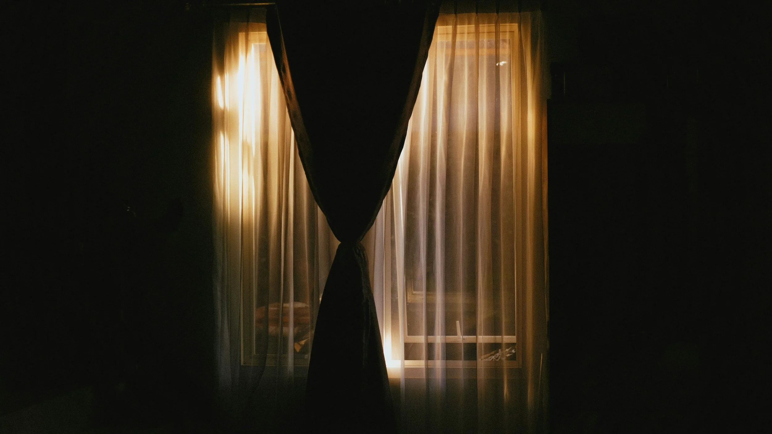 Dark blackout currents over lighter curtains meant to showcase how to create a migraine safe room