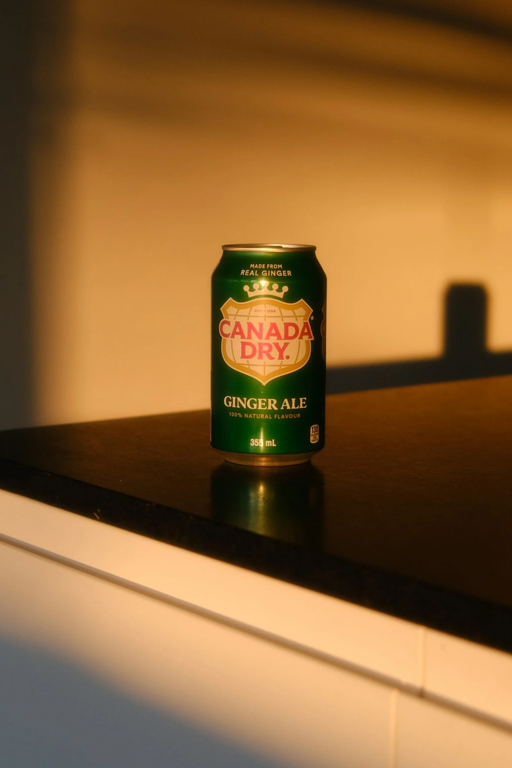 Can of Canada Dry Ginger ale sitting on a counter as a tool used for reducing nausea during a migraine attack