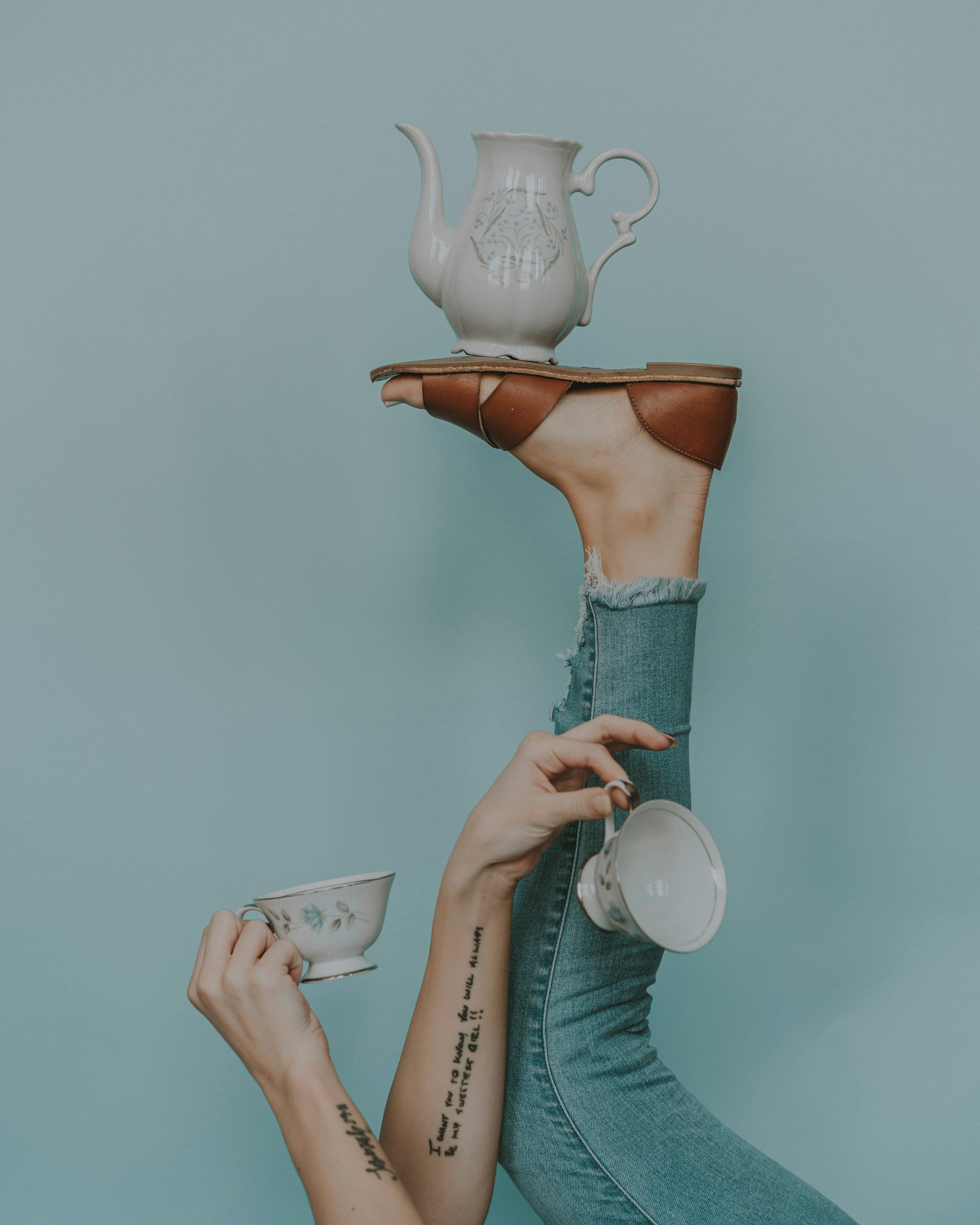 Editorial image of a teacup near a person’s foot, illustrating a story about bioplastics and sustainability.