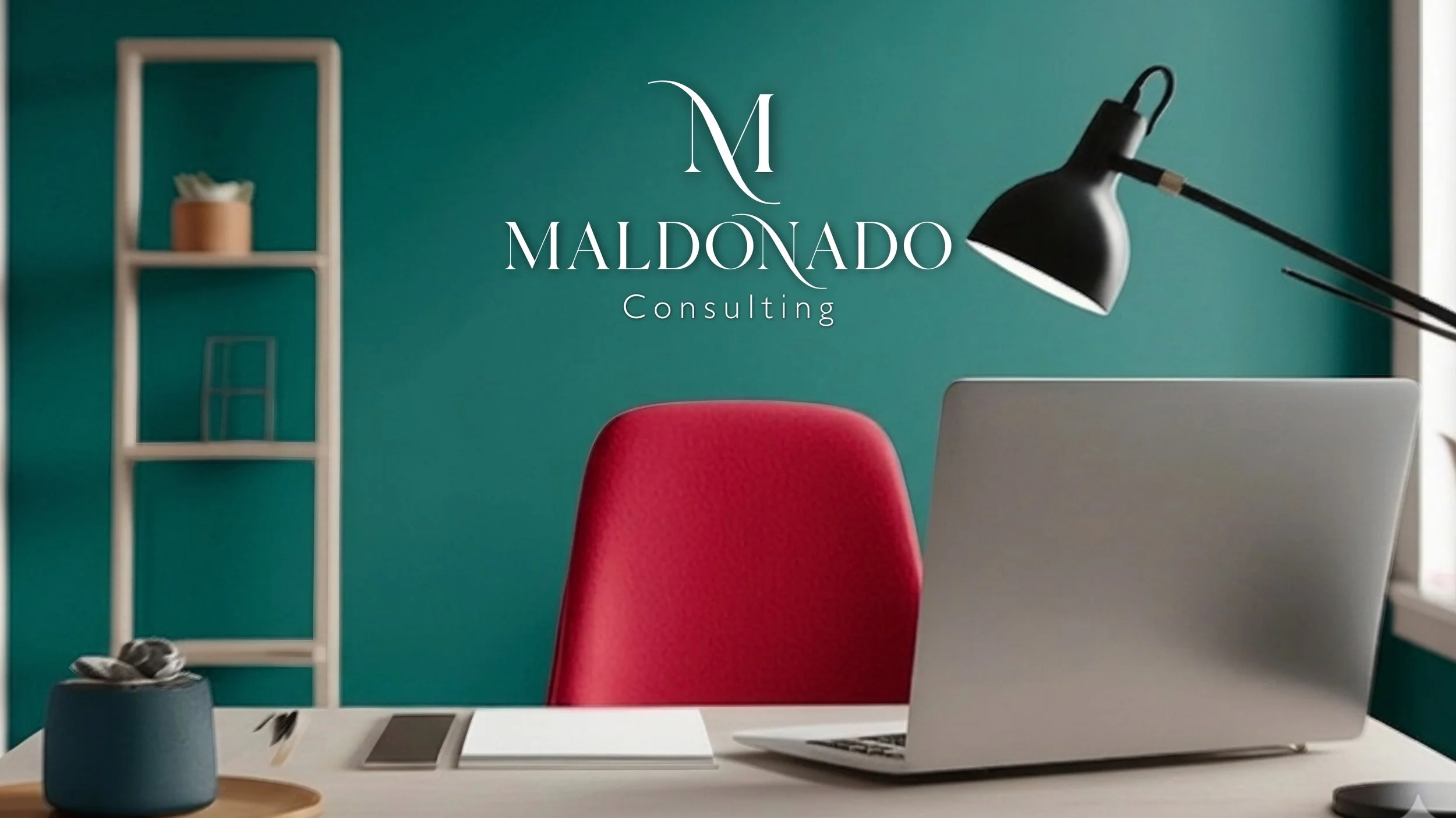 A modern office workspace with a green wall, a white desk, a silver laptop, a red office chair, a black desk lamp, a white bookshelf, and a small plant in a gray pot.