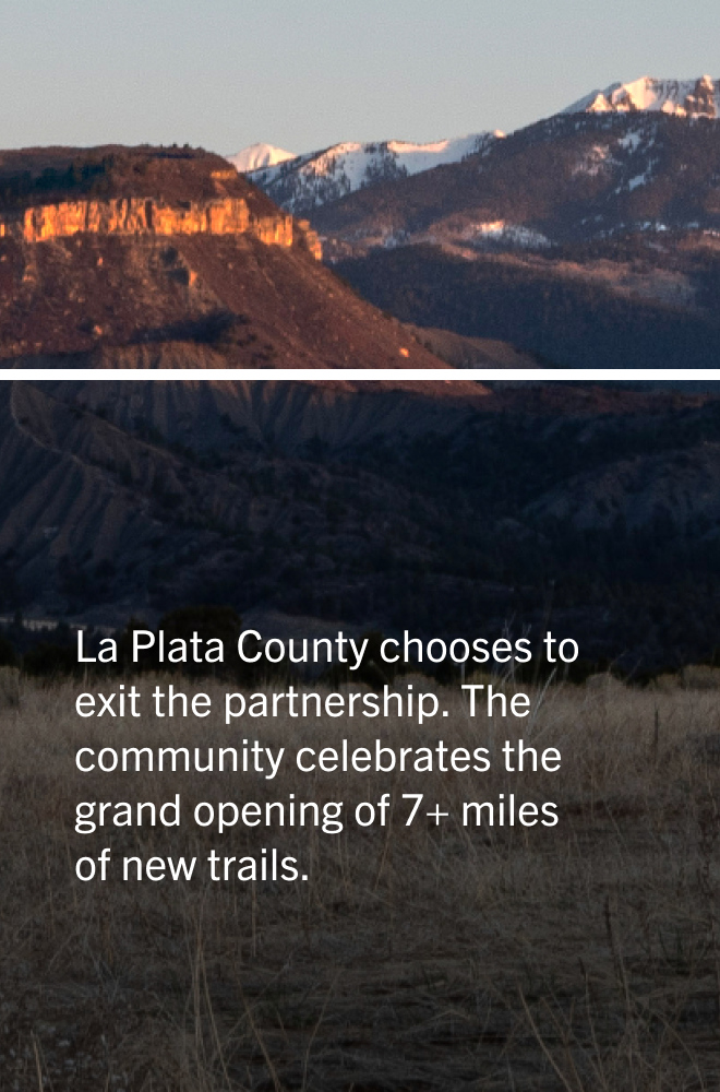 Photo of mountains with snow caps under a clear sky, with text overlay about La Plata County's new trail development.