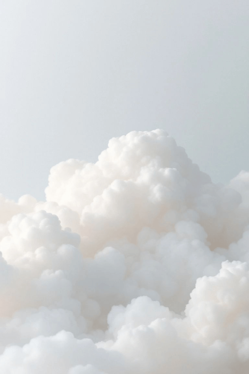 A sky filled with white, fluffy clouds with a clear, pale blue background.