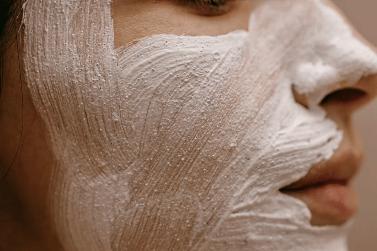 Clay mask-scrub on a woman's face, close-up during an ayurvedic facial