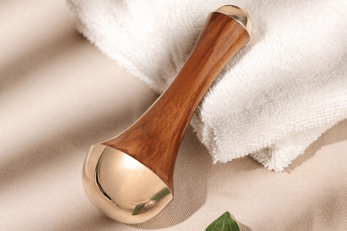 A kansa wand sitting on white towels