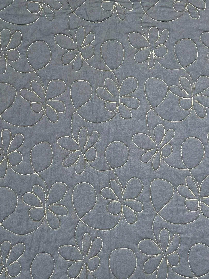 Pattern of white outlined butterfly shapes on a gray fabric background.