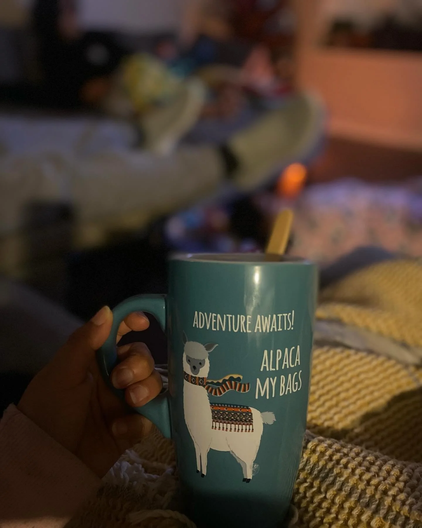 An image of a coffee mug with a drawing of an alpaca and text that says, "Adventure Awaits! Alpaca My Bags"
