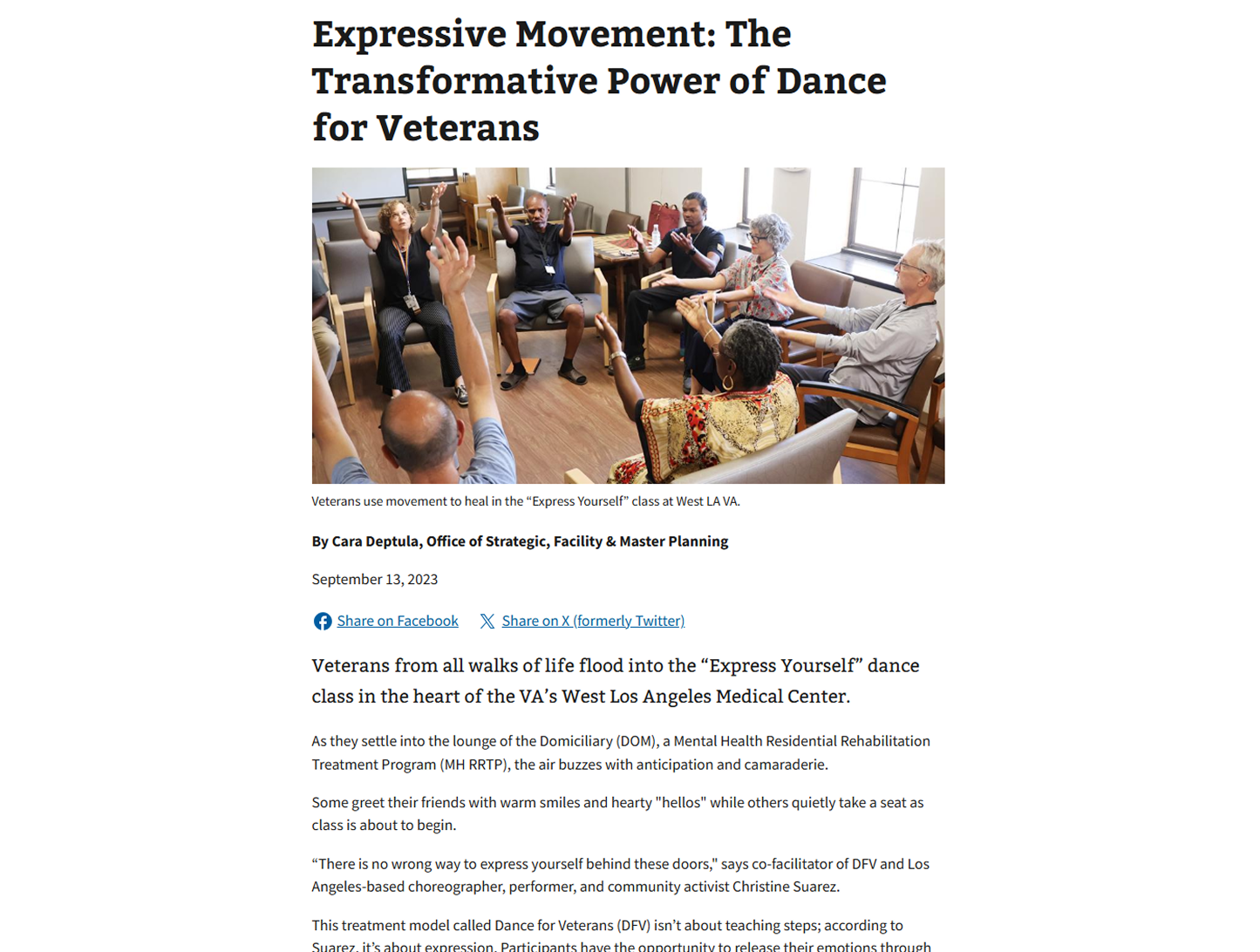 Veterans sitting in a circle in a room, participating in a movement therapy class, with some raising their hands mid-movement.