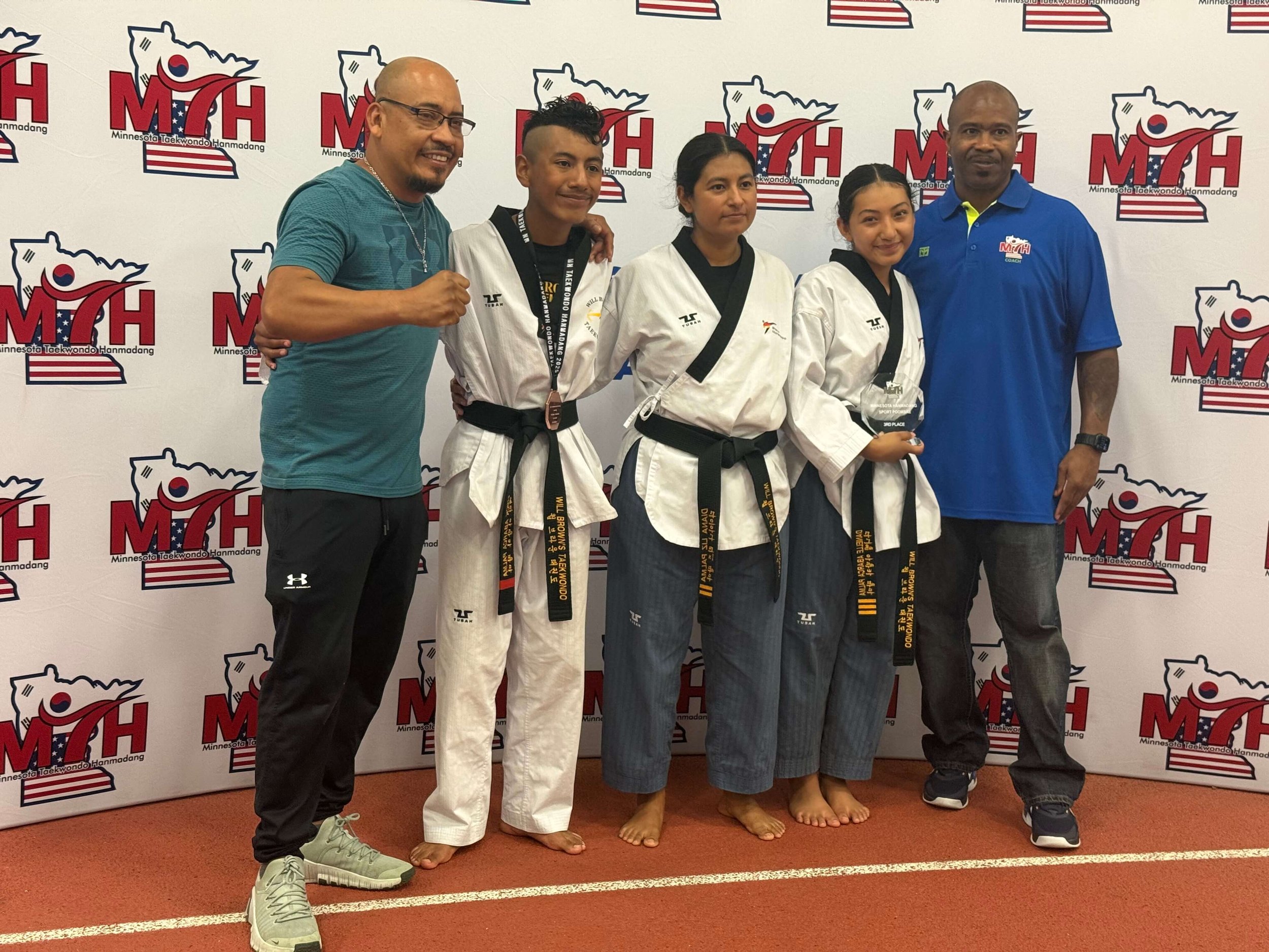 Will Brown's Taekwondo students posing with Master Will Brown and a family member after competing at the Minnesota Taekwondo Hanmadang tournament.