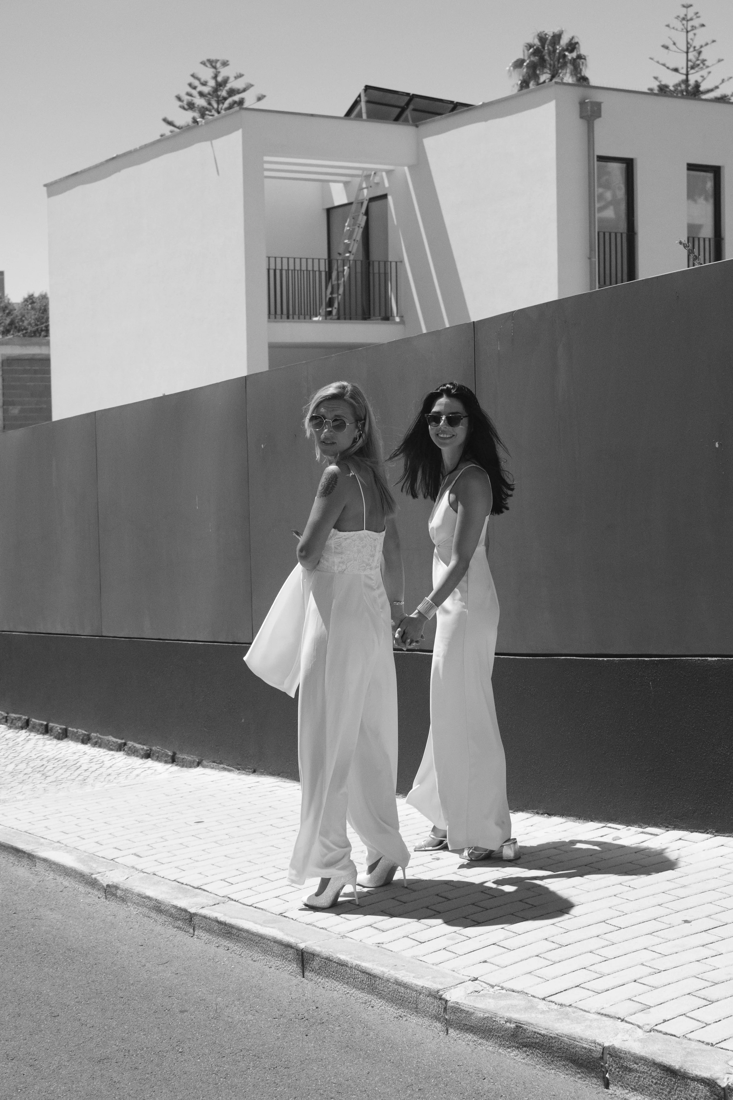 Sofia and Leonor walking hand in hand after their intimate civil ceremony in Cascais.