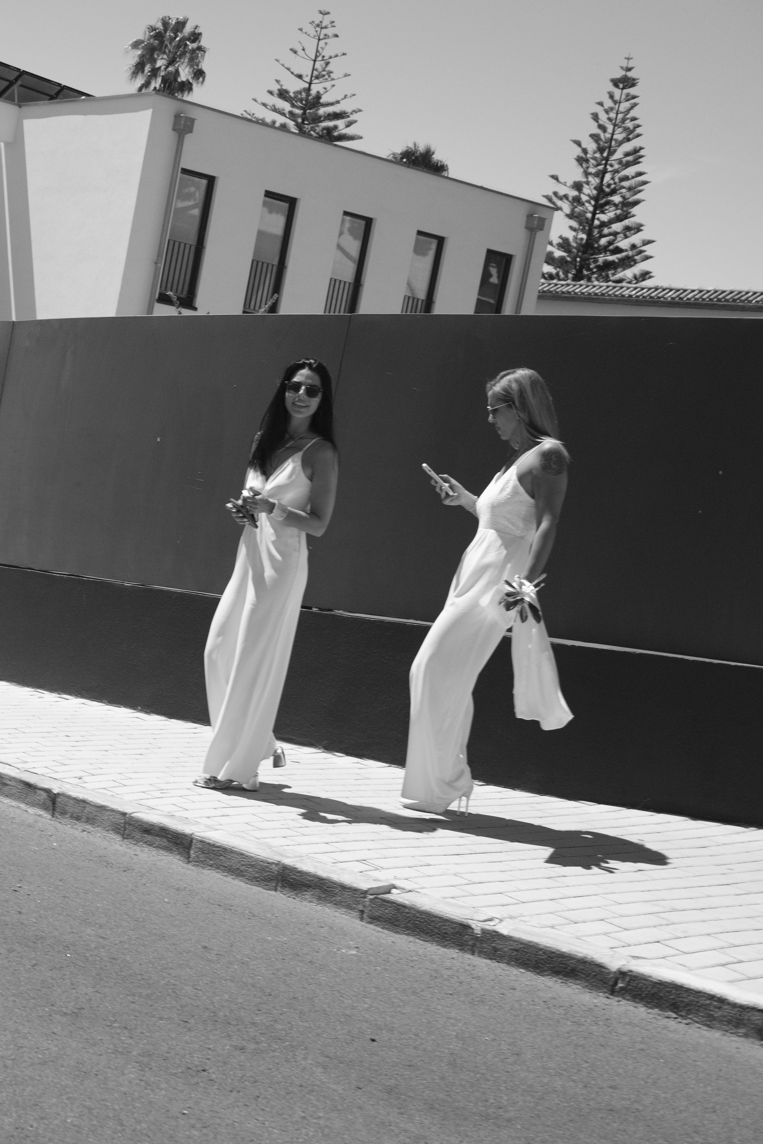 Sofia and Leonor walking together after their civil ceremony in Cascais.
