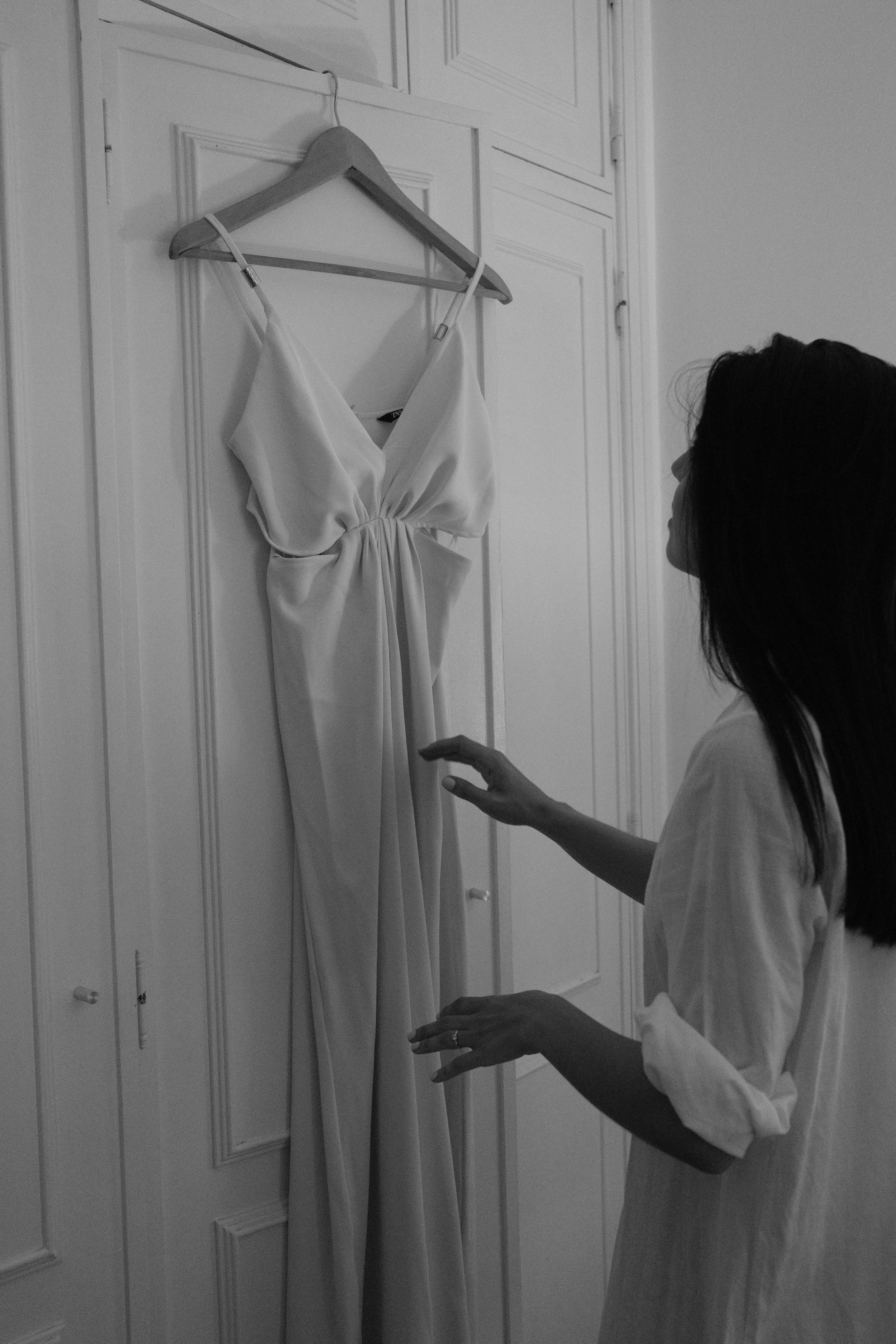 Leonor looking at her wedding dress before getting ready.