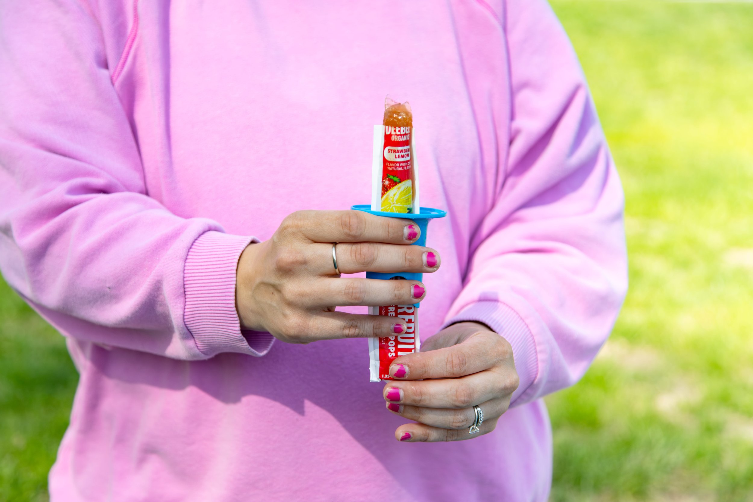 woman holding an ice pop with a pop pal