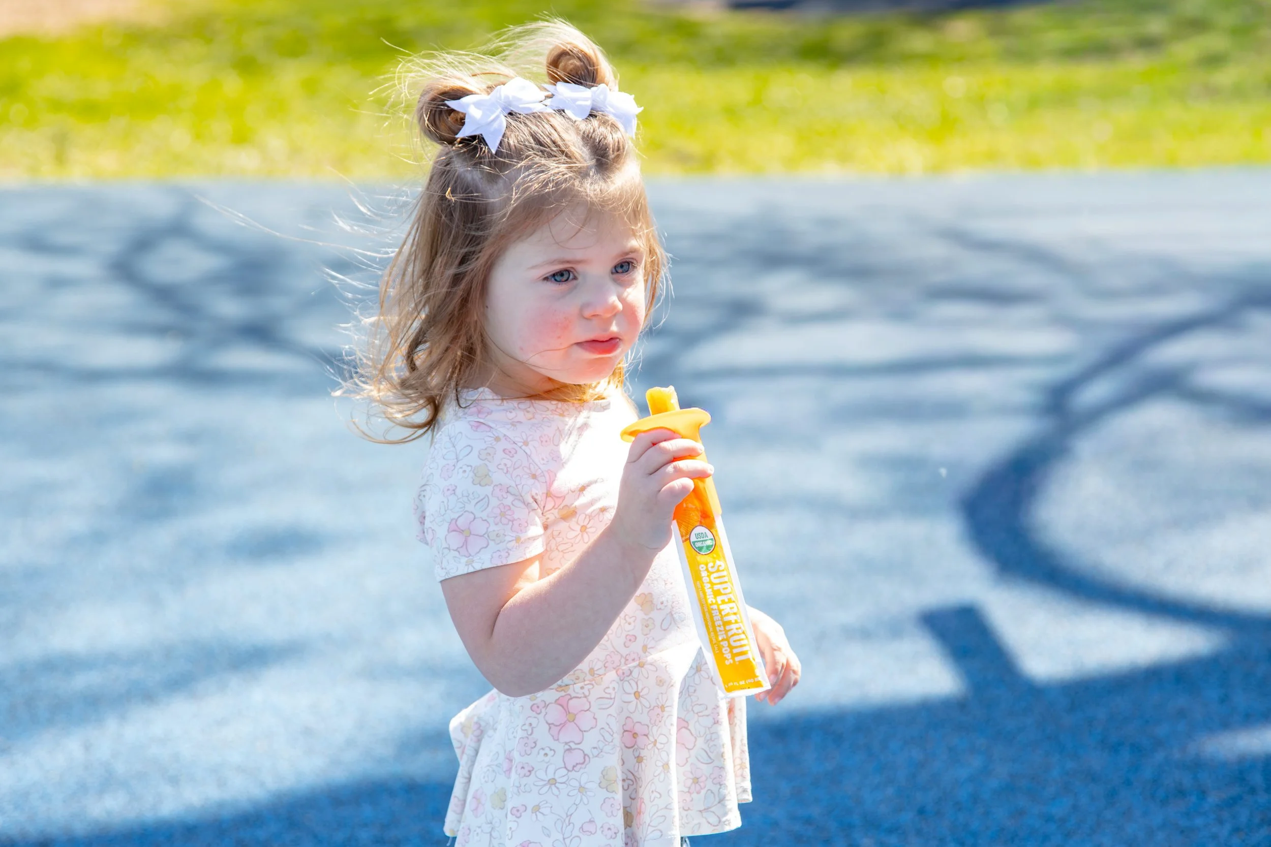 kid holding an ice pop with a pop pal