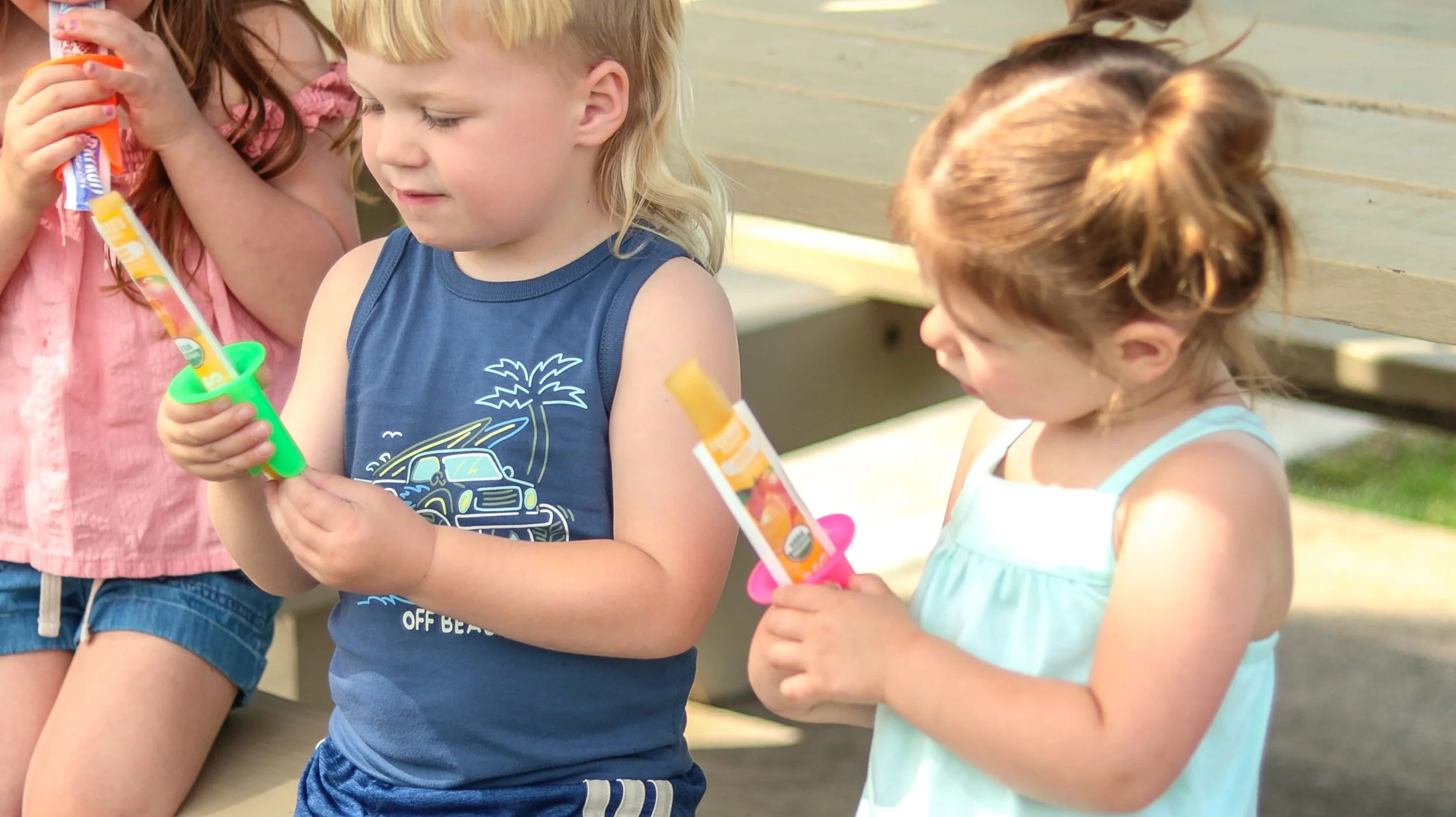 child using a pop pal to enjoy their ice pop