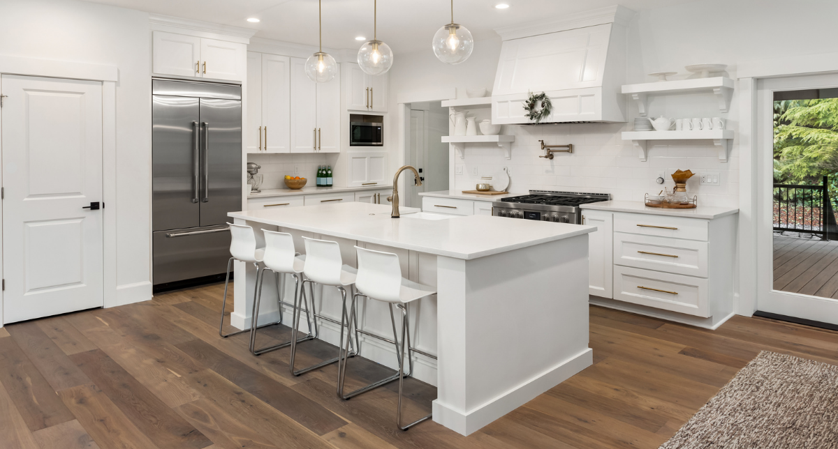 A white Tesla Model 3 electric car driving on a highway during the daytime with a clear sky and some clouds.