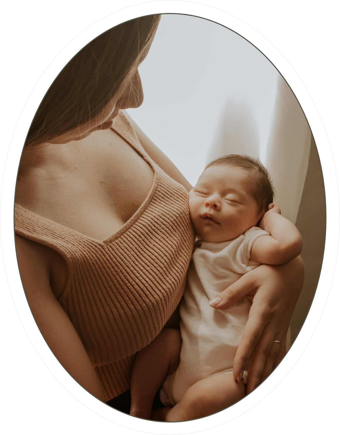 A New Jersey mother receiving full spectrum doula support from The Birth Atelier holds her newborn.