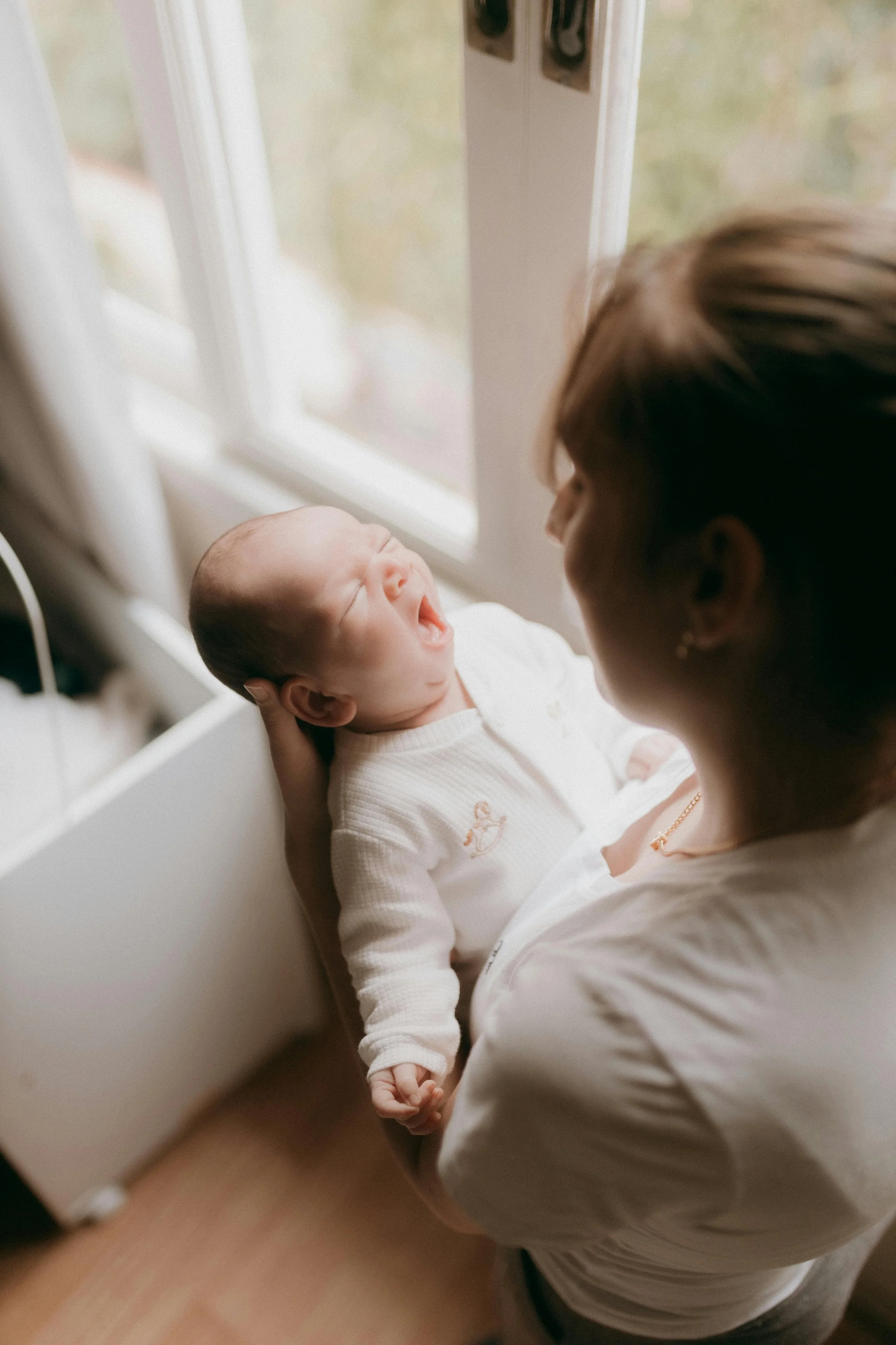 Kirsten Vogt holds a newborn in New Jersey while providing daytime postpartum doula support.