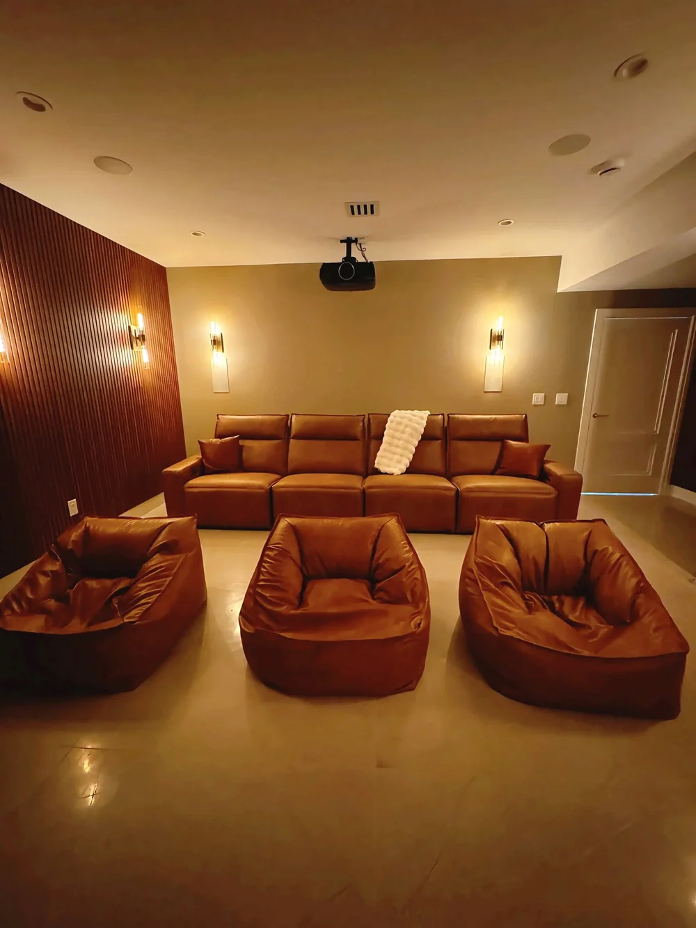 Home theater with leather seating and warm lighting