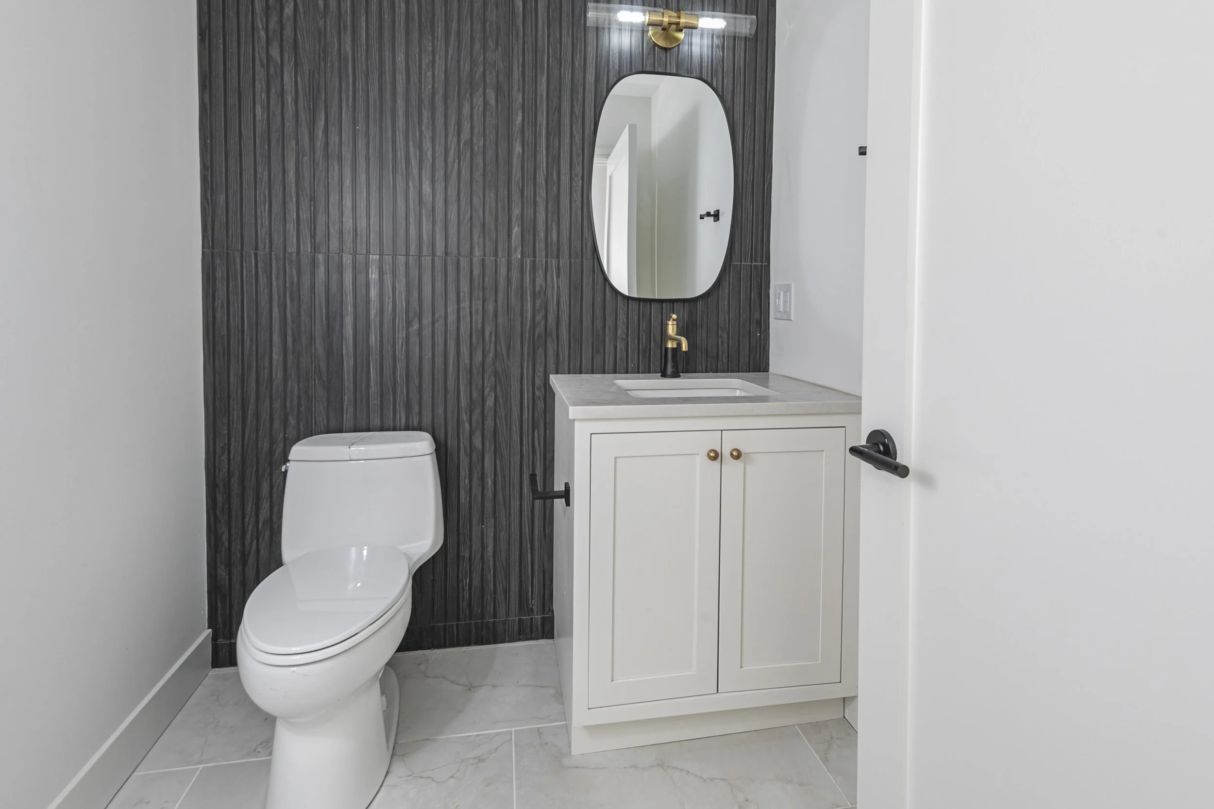 Oak Haven dark tile powder room