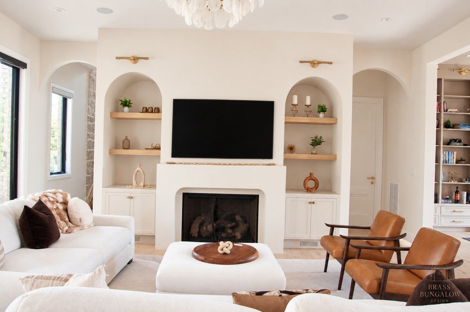 Great room with a curved plaster fireplace and layered seating