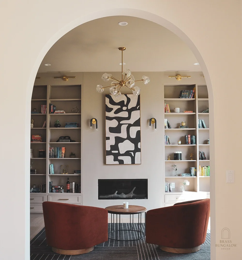 Den with built-in shelving and a cozy reading corner