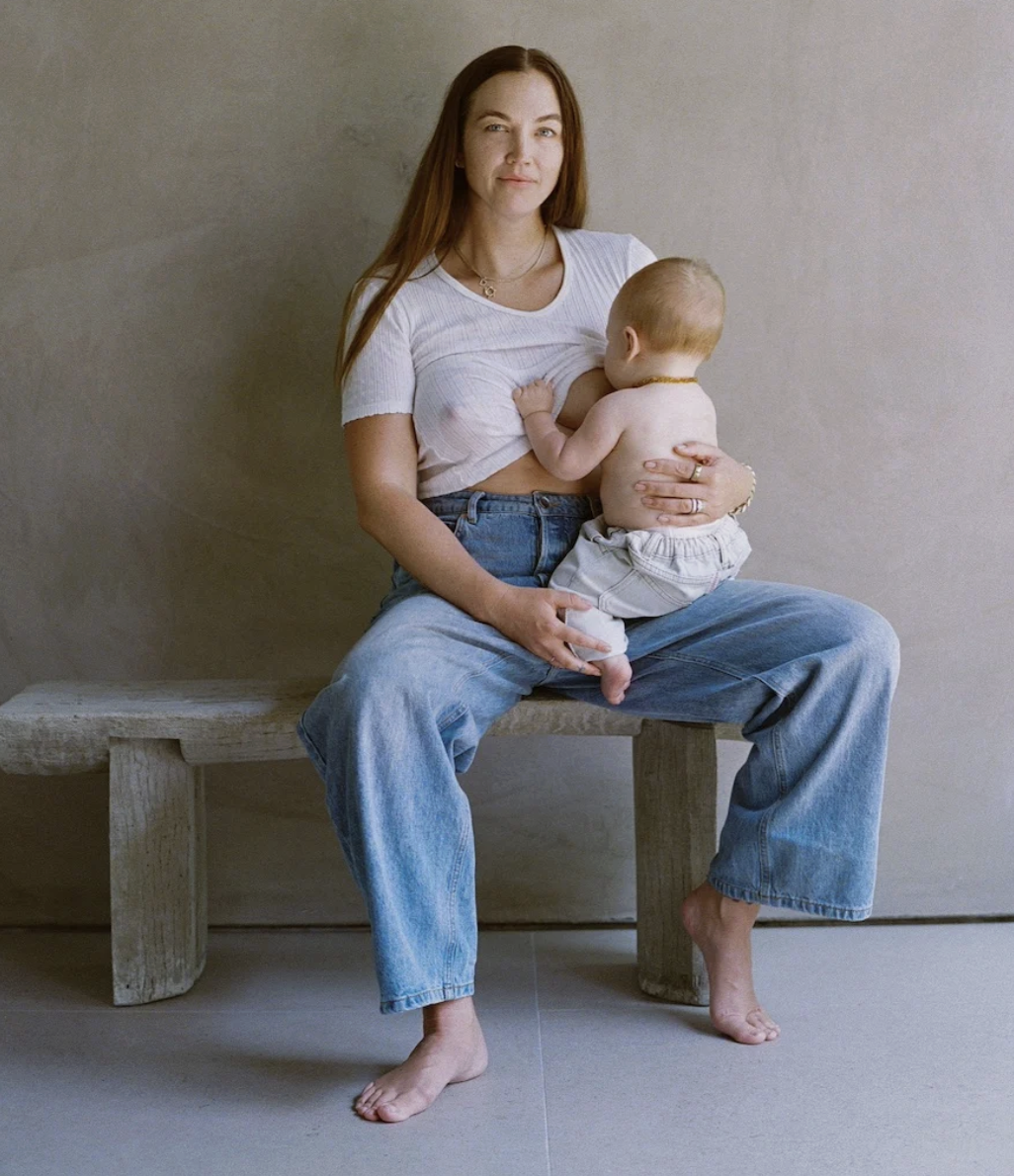 A mother breastfeeding a baby, advertising Mothership Milk, on Rachel Bernhard's Baby Registry page.