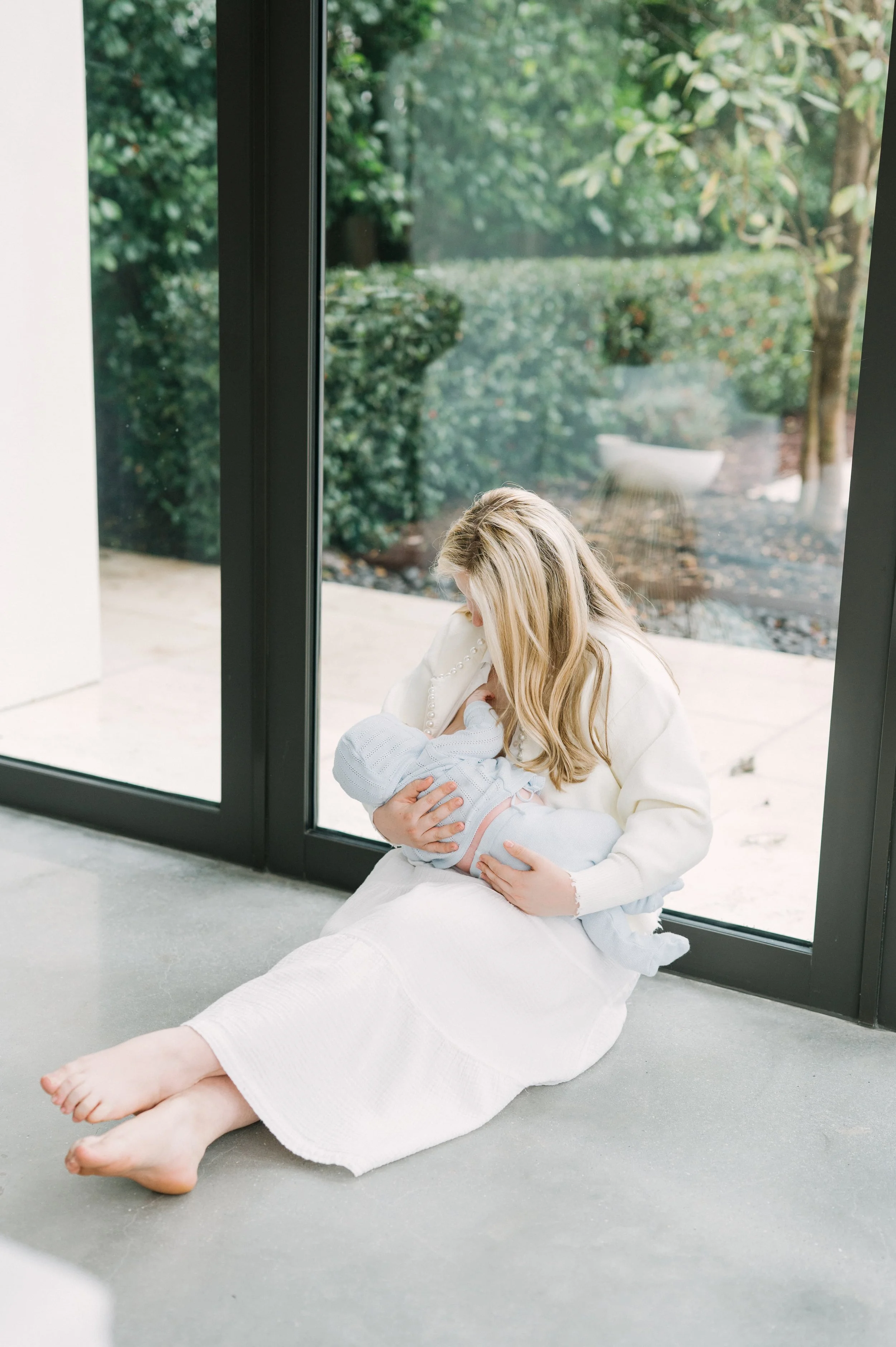 Founder of the virtual motherhood circle The Postpartum Village, Rachel Bernhard, breastfeeds her newborn.