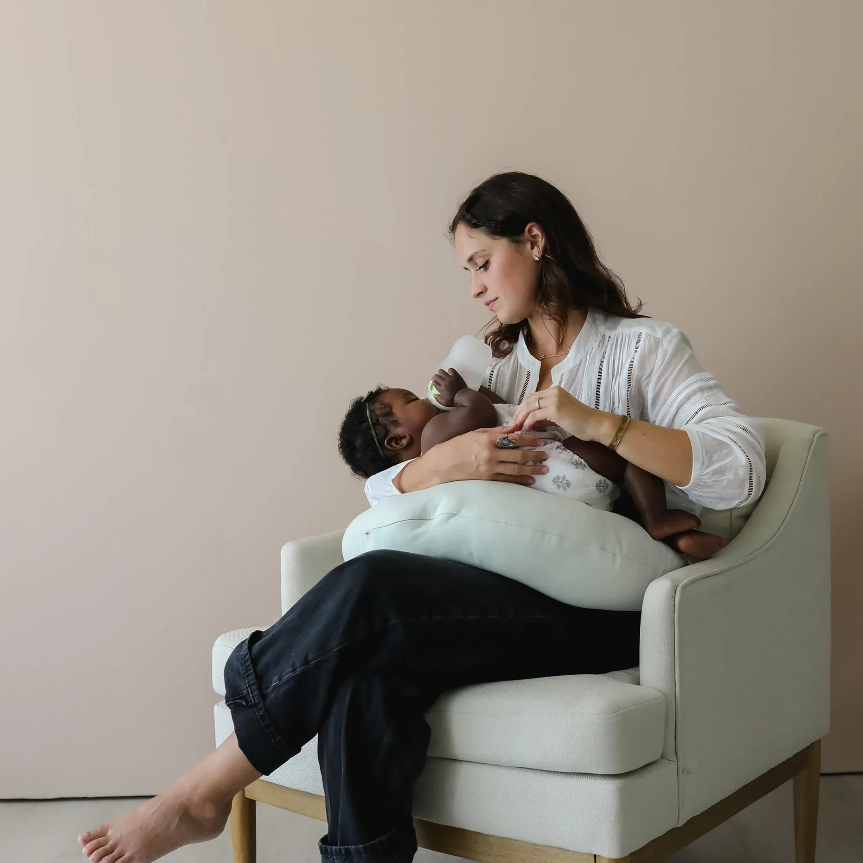 Mom using the Snuggle Me Organic Nursing and feeding pillows on Rachel Bernhard's Baby Registry page.