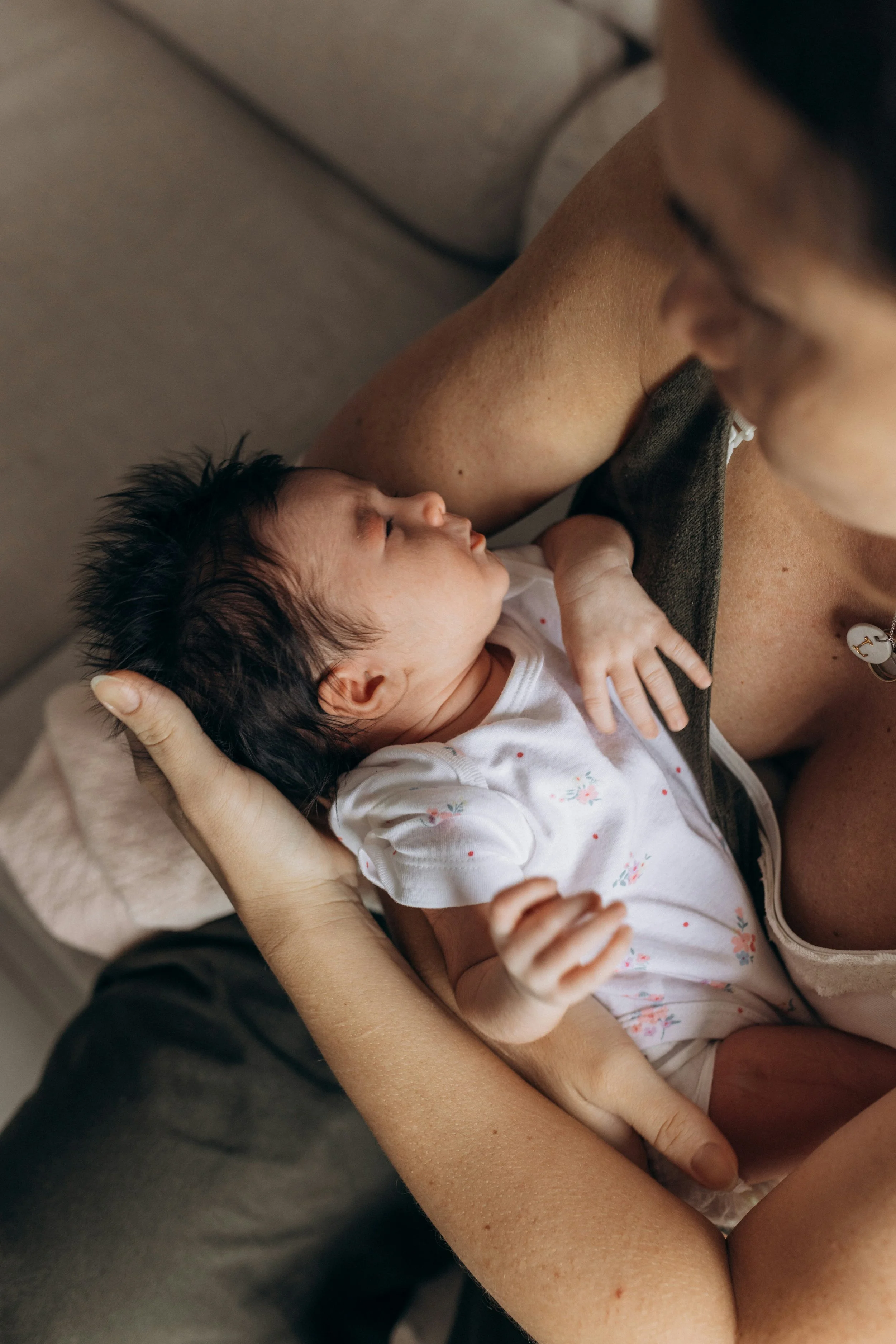A mother holds her baby after a 1:1 sleep consult virtual session with Rachel Bernhard.