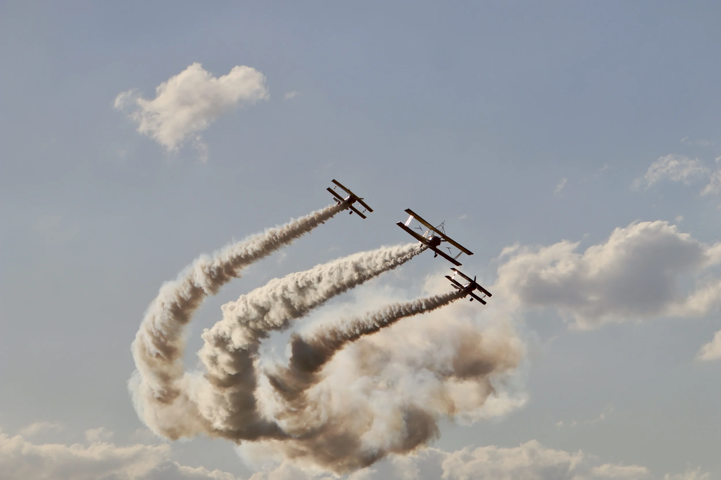Three aerobatic planes in formation