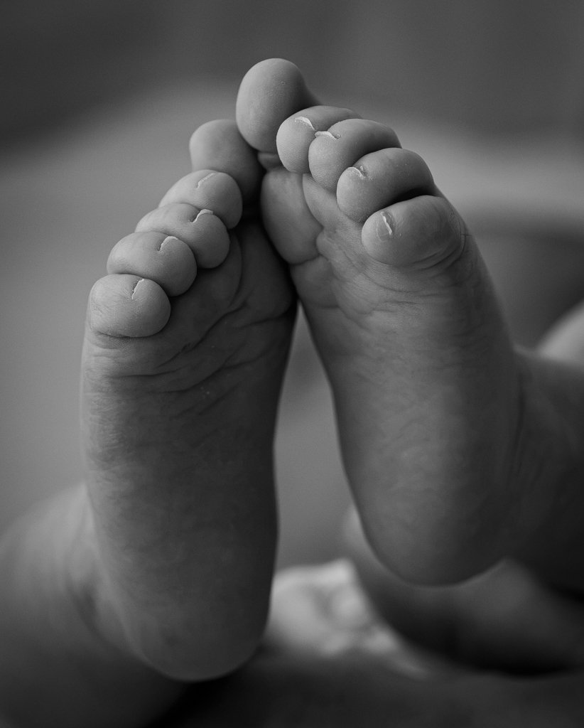 Close-up of two tiny baby feet pressed together