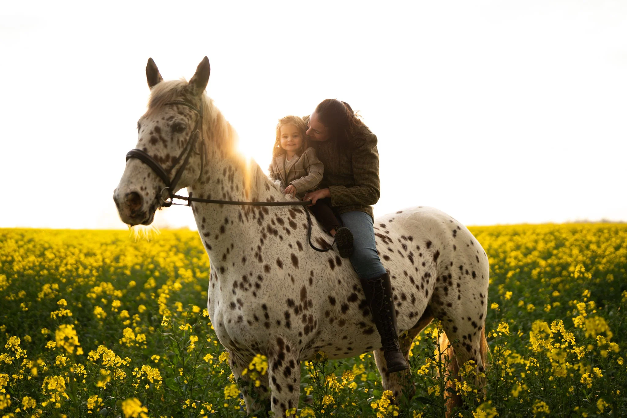 Mum and daughter on a beautiful spotty horse