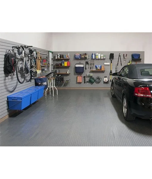 Garage with organized tools and equipment, bicycle, storage bins, and a parked car.