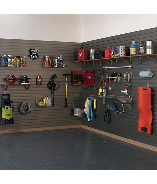 Garage storage with tools, supplies, and equipment organized on the wall, including shelves, hooks, and cabinets.
