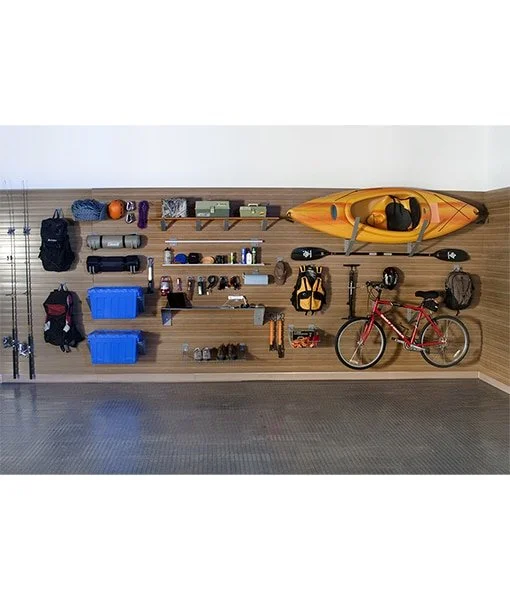 Organized wall with outdoor gear including a kayak, bicycle, helmets, backpacks, and storage containers in a garage.