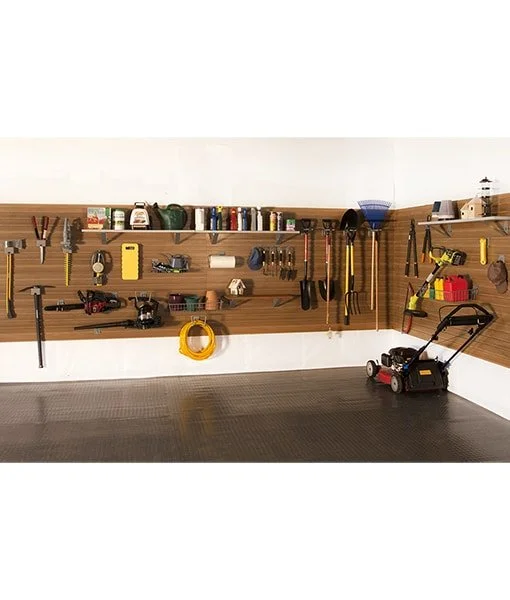 Garage wall with organized tools and equipment, including a lawnmower on a tiled floor.