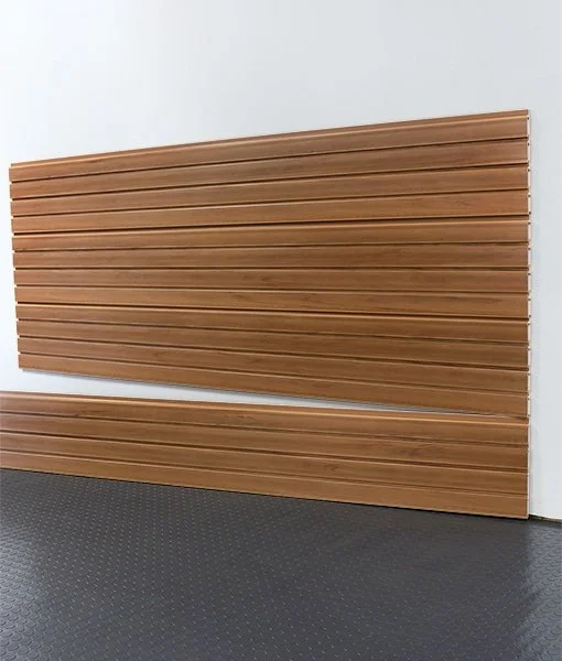 Wooden slat wall panel leaning against a white wall, with a matching wood slat bench below it.