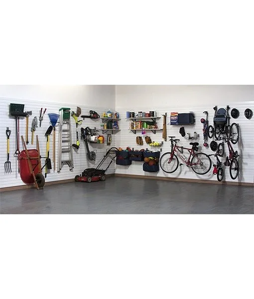 Garage wall with various gardening tools, a push lawn mower, outdoor toys, and a red bicycle.