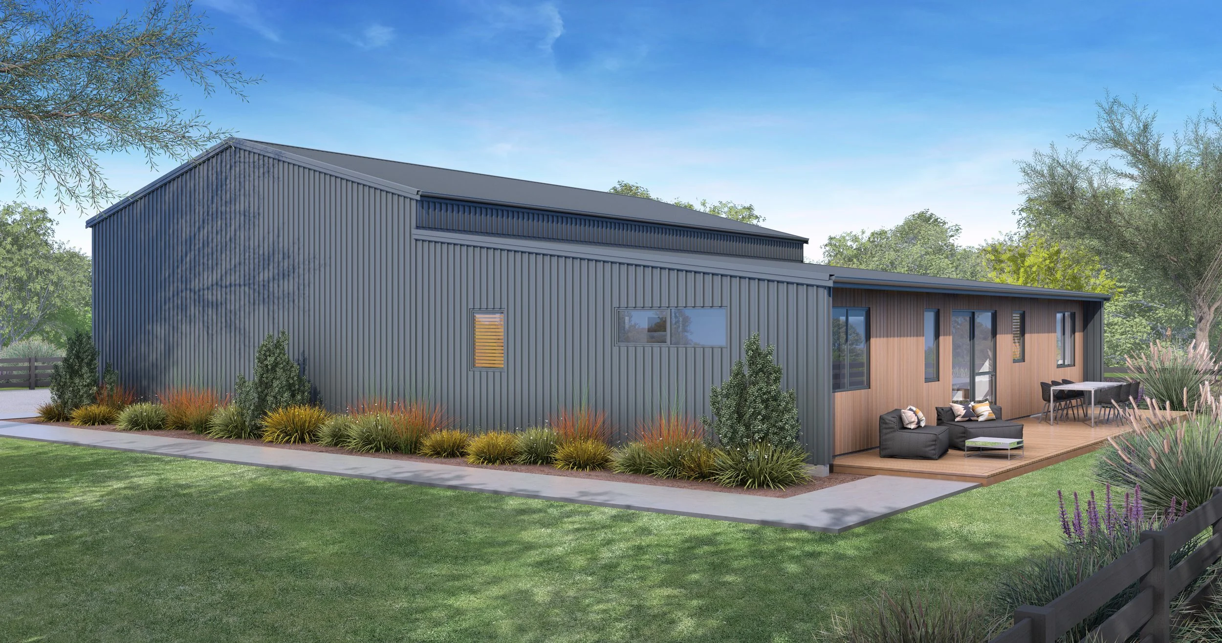 Modern house with metal siding and wooden deck, outdoor furniture, and landscaped yard with bushes and trees, under a blue sky.